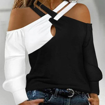 A stylish women's top with a black and white patchwork design, featuring a cross-belt accent for a fashionable casual look.