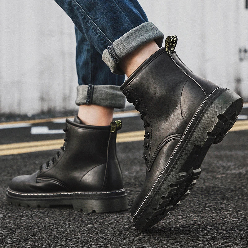 A pair of black leather cowboy boots with a high-cut design and classic western-inspired stitching