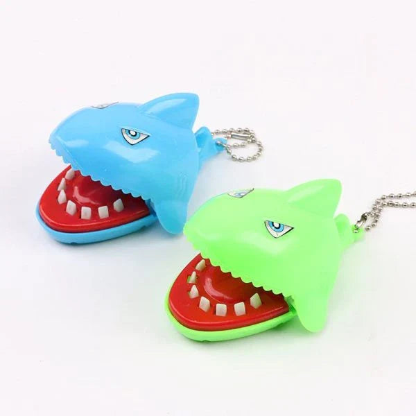 A realistic-looking shark-shaped biting finger toy that provides a satisfying snap when pressed down on.