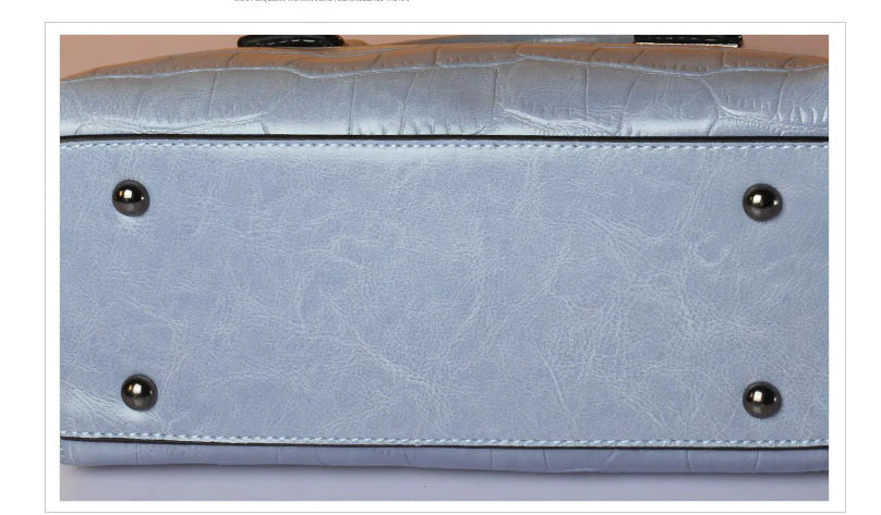 A stylish and functional cowhide leather women's shoulder bag with a unique crocodile pattern design