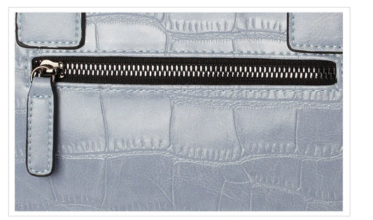 A stylish and functional cowhide leather women's shoulder bag with a unique crocodile pattern design