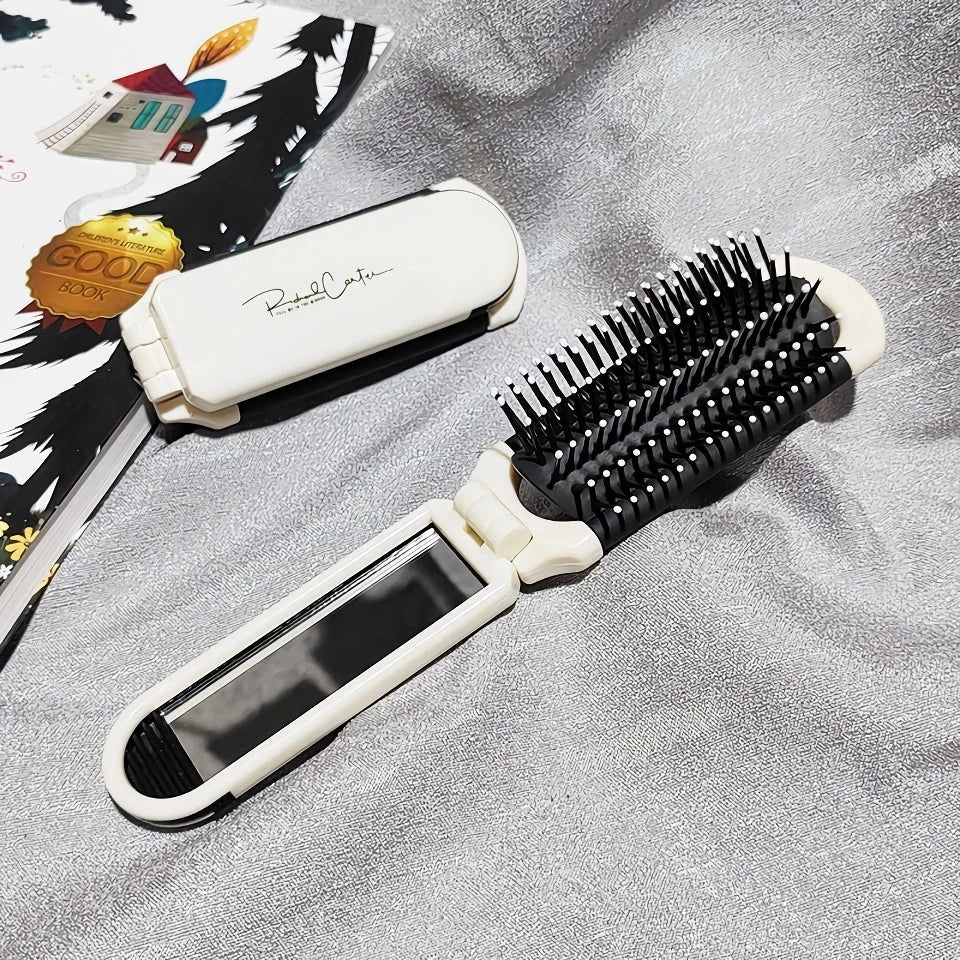 A portable, foldable hair brush with a built-in mirror for on-the-go grooming and touch-ups