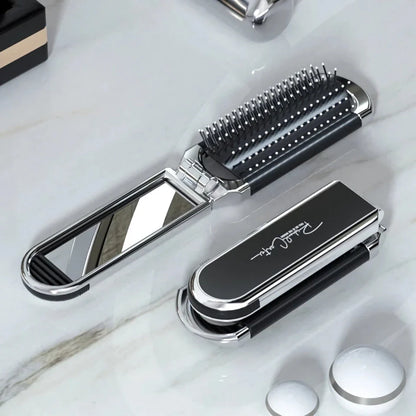 A portable, foldable hair brush with a built-in mirror for on-the-go grooming and touch-ups