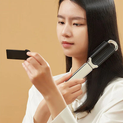 A portable, foldable hair brush with a built-in mirror for on-the-go grooming and touch-ups