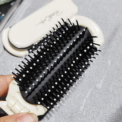 A portable, foldable hair brush with a built-in mirror for on-the-go grooming and touch-ups
