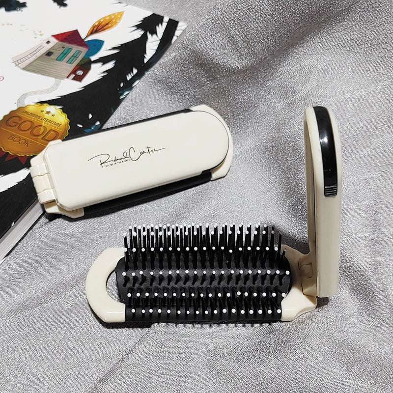 A portable, foldable hair brush with a built-in mirror for on-the-go grooming and touch-ups
