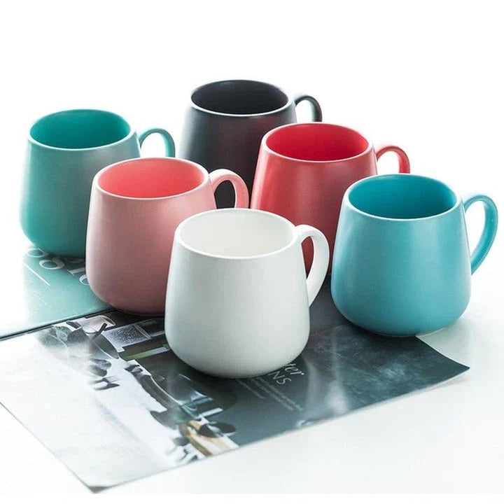 A modern, matte-textured ceramic coffee mug in a variety of colors, with a comfortable handle and generous 10.82 oz capacity.
