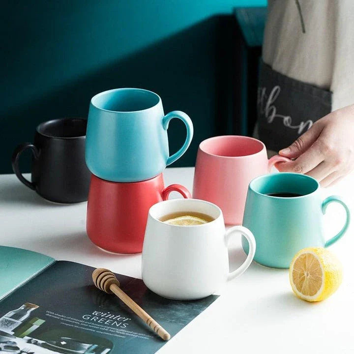 A modern, matte-textured ceramic coffee mug in a variety of colors, with a comfortable handle and generous 10.82 oz capacity.