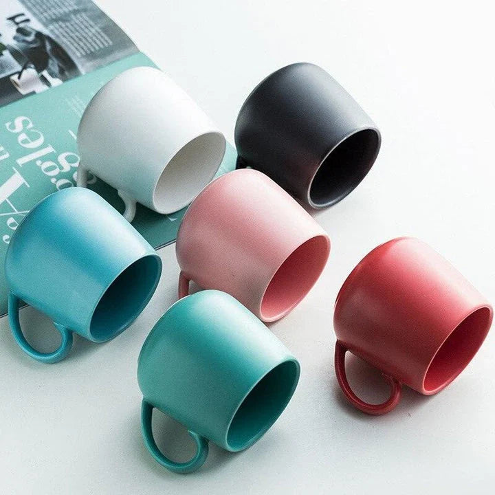A modern, matte-textured ceramic coffee mug in a variety of colors, with a comfortable handle and generous 10.82 oz capacity.