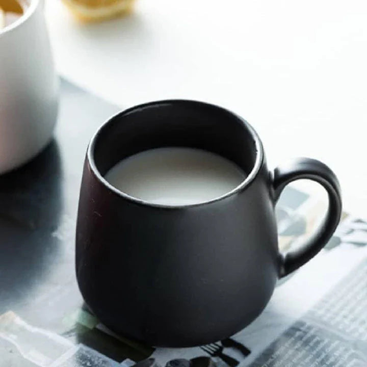 A modern, matte-textured ceramic coffee mug in a variety of colors, with a comfortable handle and generous 10.82 oz capacity.
