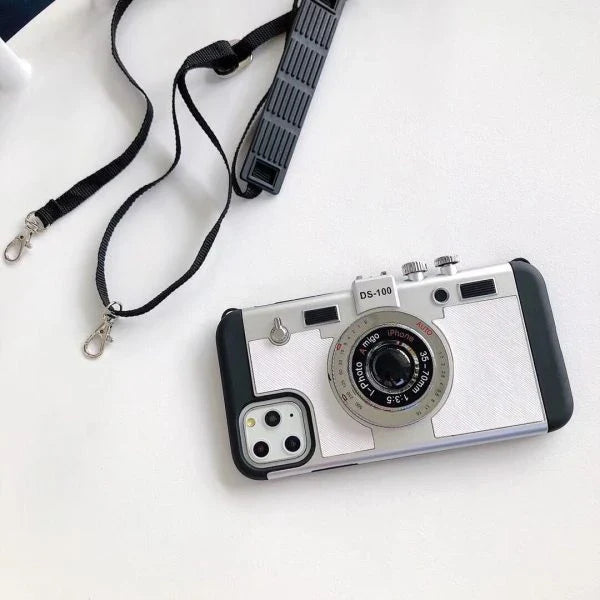 Retro-inspired shatterproof phone case with camera-style design, available in black, brown, and gray colors for iPhone 12/13 models.