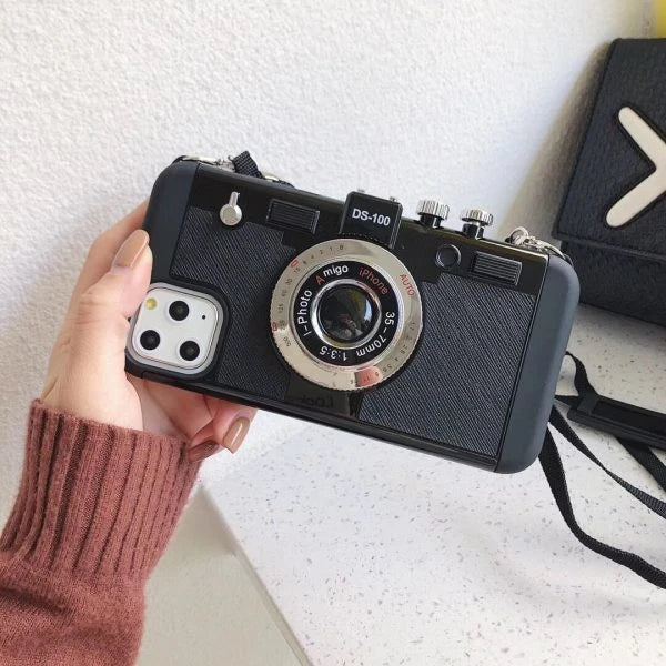 Retro-inspired shatterproof phone case with camera-style design, available in black, brown, and gray colors for iPhone 12/13 models.