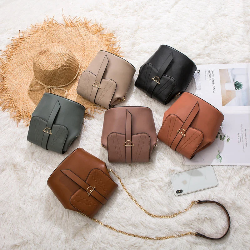 A stylish and practical large capacity chain bag in orange, featuring a bucket-style design and multiple internal pockets for organization.