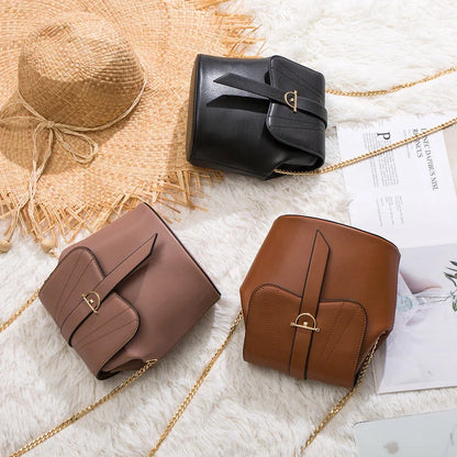 A stylish and practical large capacity chain bag in orange, featuring a bucket-style design and multiple internal pockets for organization.