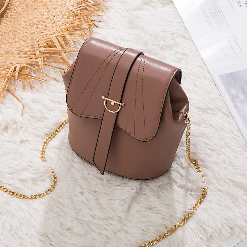 A stylish and practical large capacity chain bag in orange, featuring a bucket-style design and multiple internal pockets for organization.