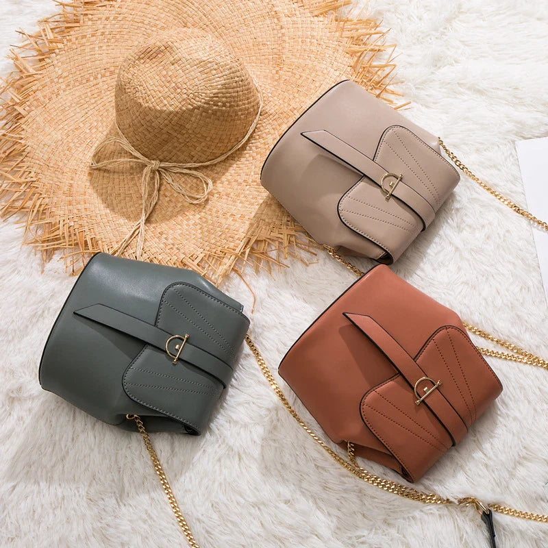 A stylish and practical large capacity chain bag in orange, featuring a bucket-style design and multiple internal pockets for organization.