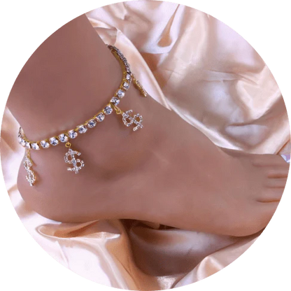 Fashionable gold-colored anklet with four dollar-shaped pendants adorned with rhinestones