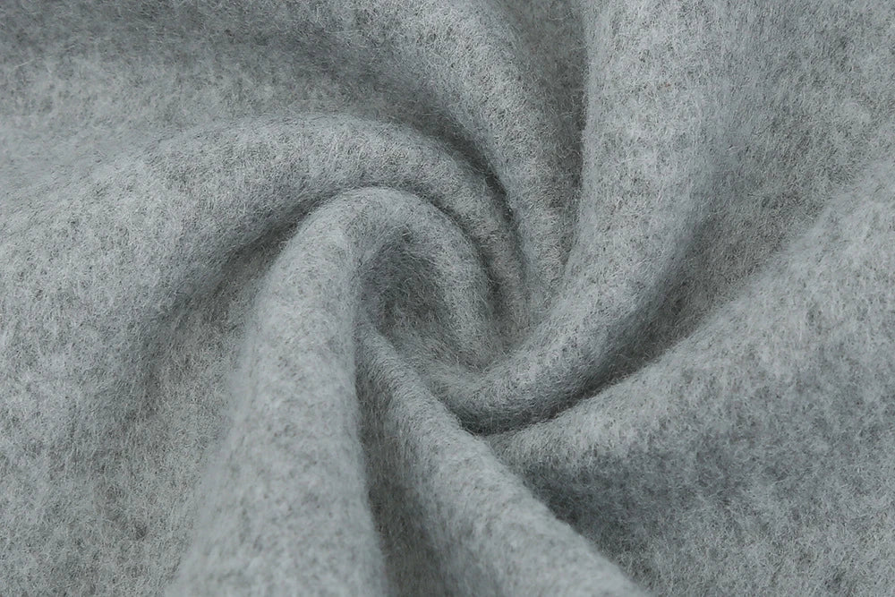 Fashionable solid color woolen coat with a stand collar, designed for warmth and style during the winter season.