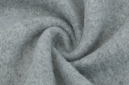 Fashionable solid color woolen coat with a stand collar, designed for warmth and style during the winter season.