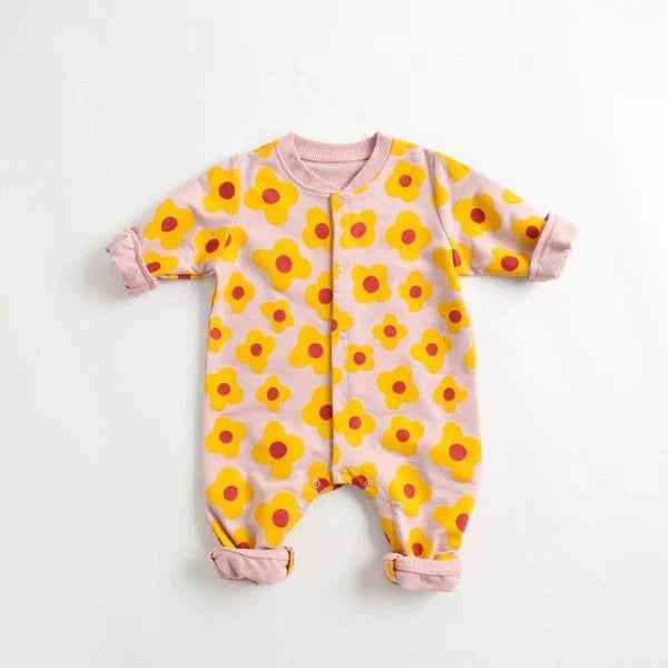 Adorable baby wearing a cartoon-printed long-sleeved romper, playing and exploring comfortably.