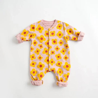 Adorable baby wearing a cartoon-printed long-sleeved romper, playing and exploring comfortably.