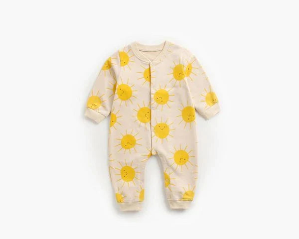 Adorable baby wearing a cartoon-printed long-sleeved romper, playing and exploring comfortably.