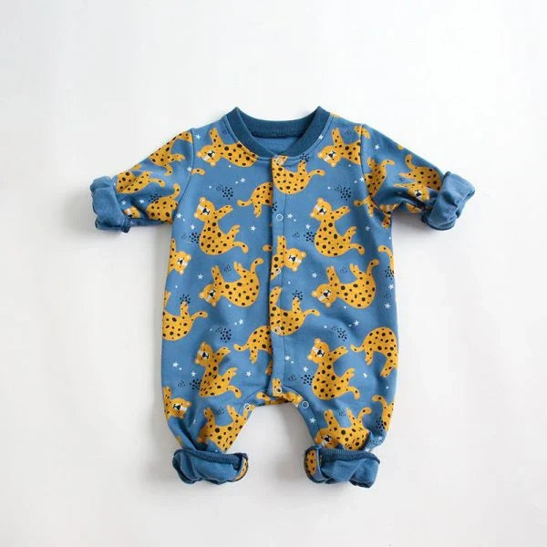 Adorable baby wearing a cartoon-printed long-sleeved romper, playing and exploring comfortably.