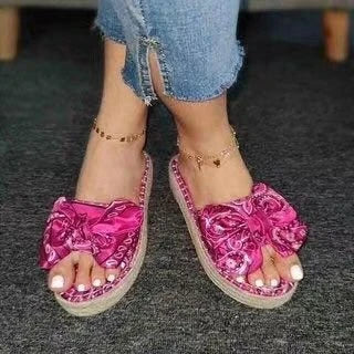 Pair of hemp straw bow slippers with satin material, available in blue, black, and pink colors