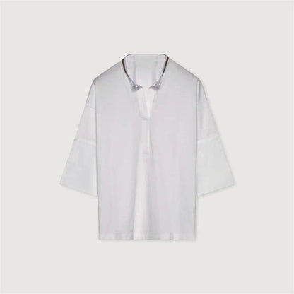 A white t-shirt with a bead chain detail around the neckline and a split hem design, perfect for summer