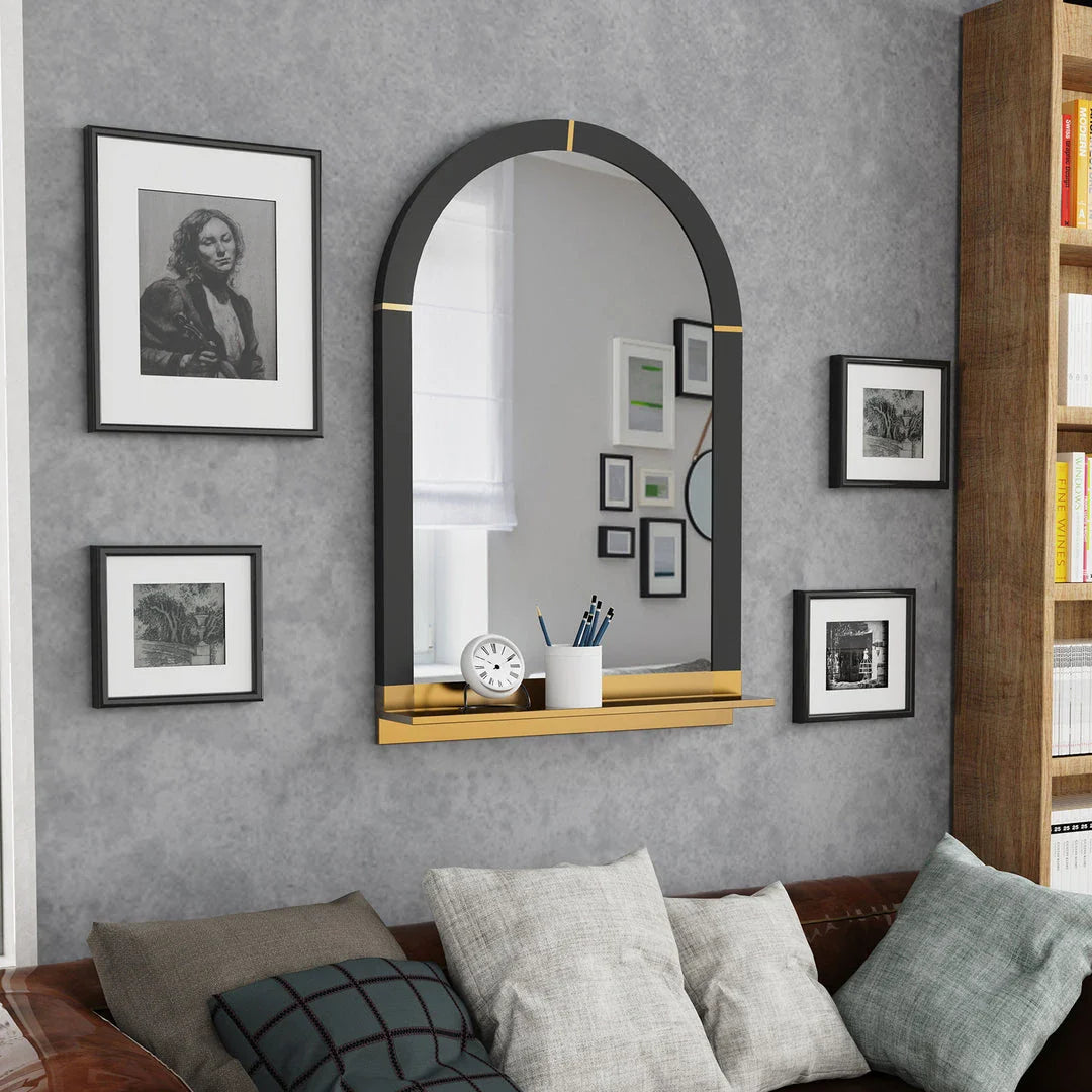 Arched black and gold wall mirror with decorative shelf, perfect for enhancing the style and functionality of any room.