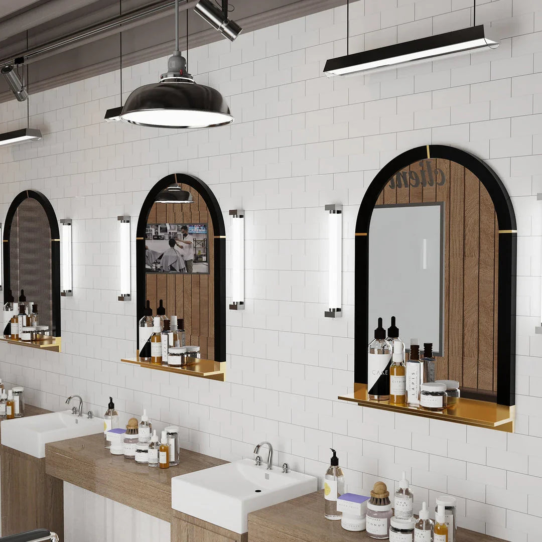 Arched black and gold wall mirror with decorative shelf, perfect for enhancing the style and functionality of any room.