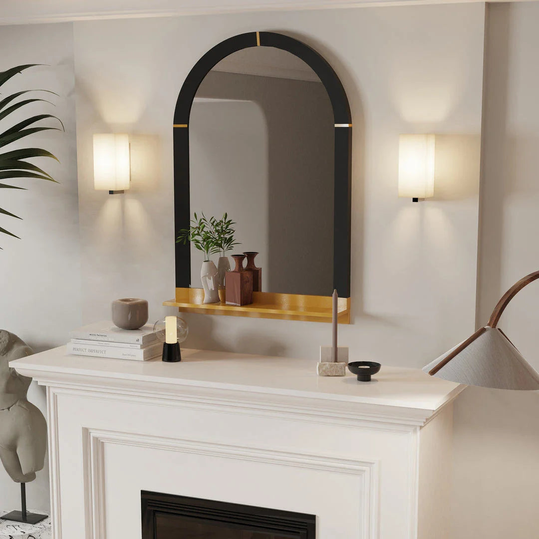 Arched black and gold wall mirror with decorative shelf, perfect for enhancing the style and functionality of any room.
