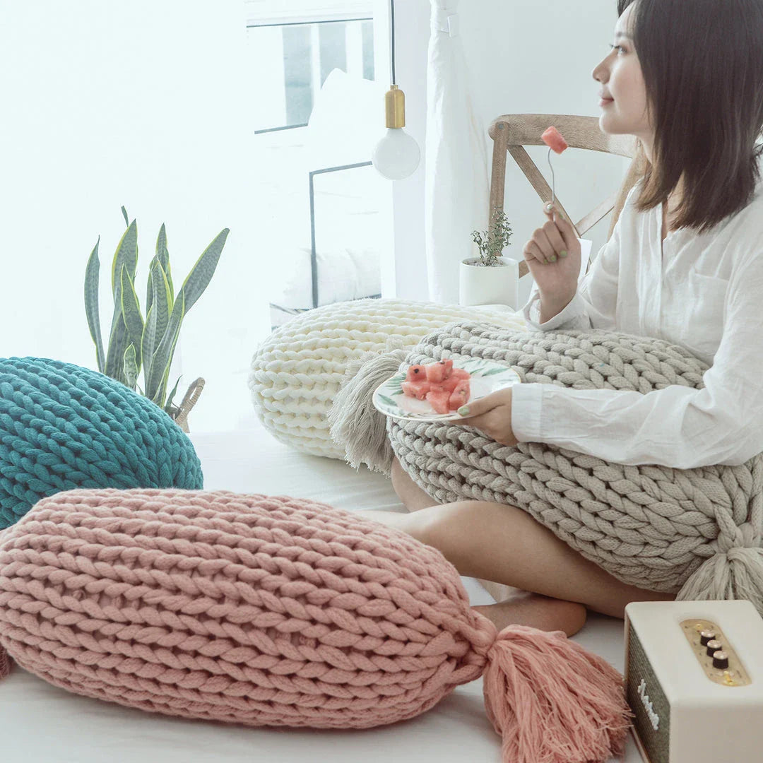 Soft and fluffy white chunky knit pillow in the shape of a candy with a kawaii tassel design, perfect for adding a playful touch to your home decor.