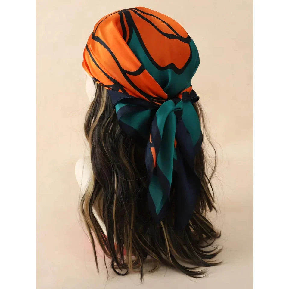 Chic Silk Square Scarf in orange color with whimsical cat print design, a luxurious and versatile fashion accessory.