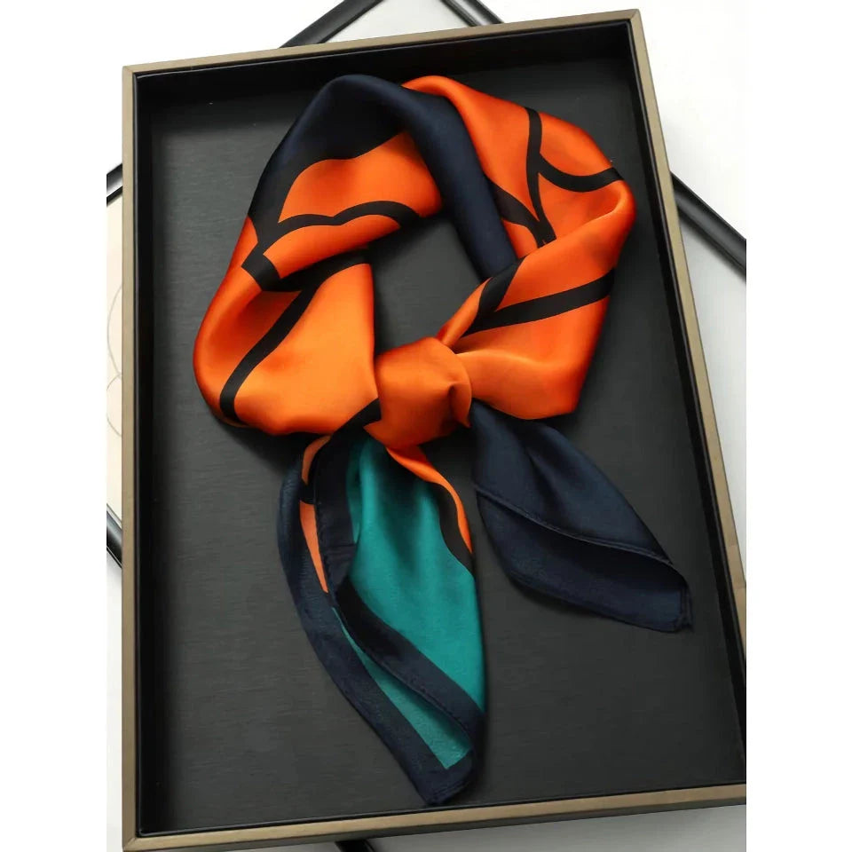 Chic Silk Square Scarf in orange color with whimsical cat print design, a luxurious and versatile fashion accessory.