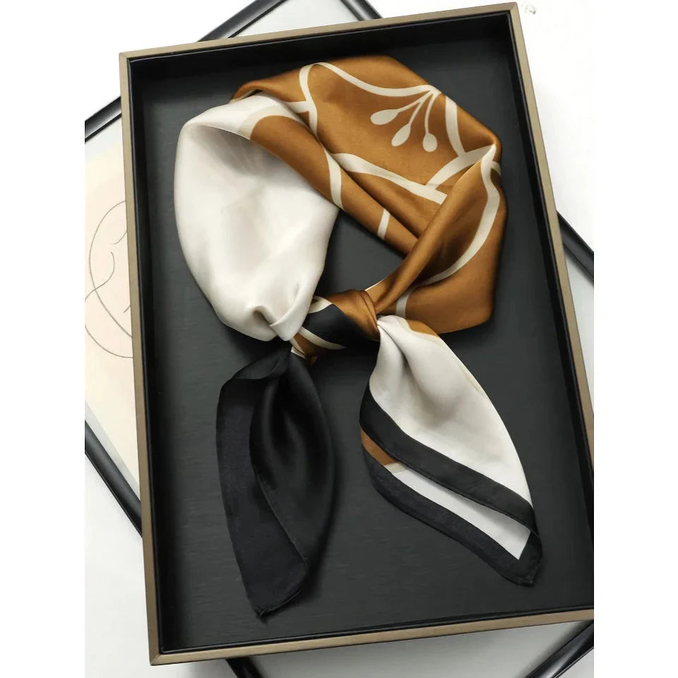 Chic Silk Square Scarf in orange color with whimsical cat print design, a luxurious and versatile fashion accessory.