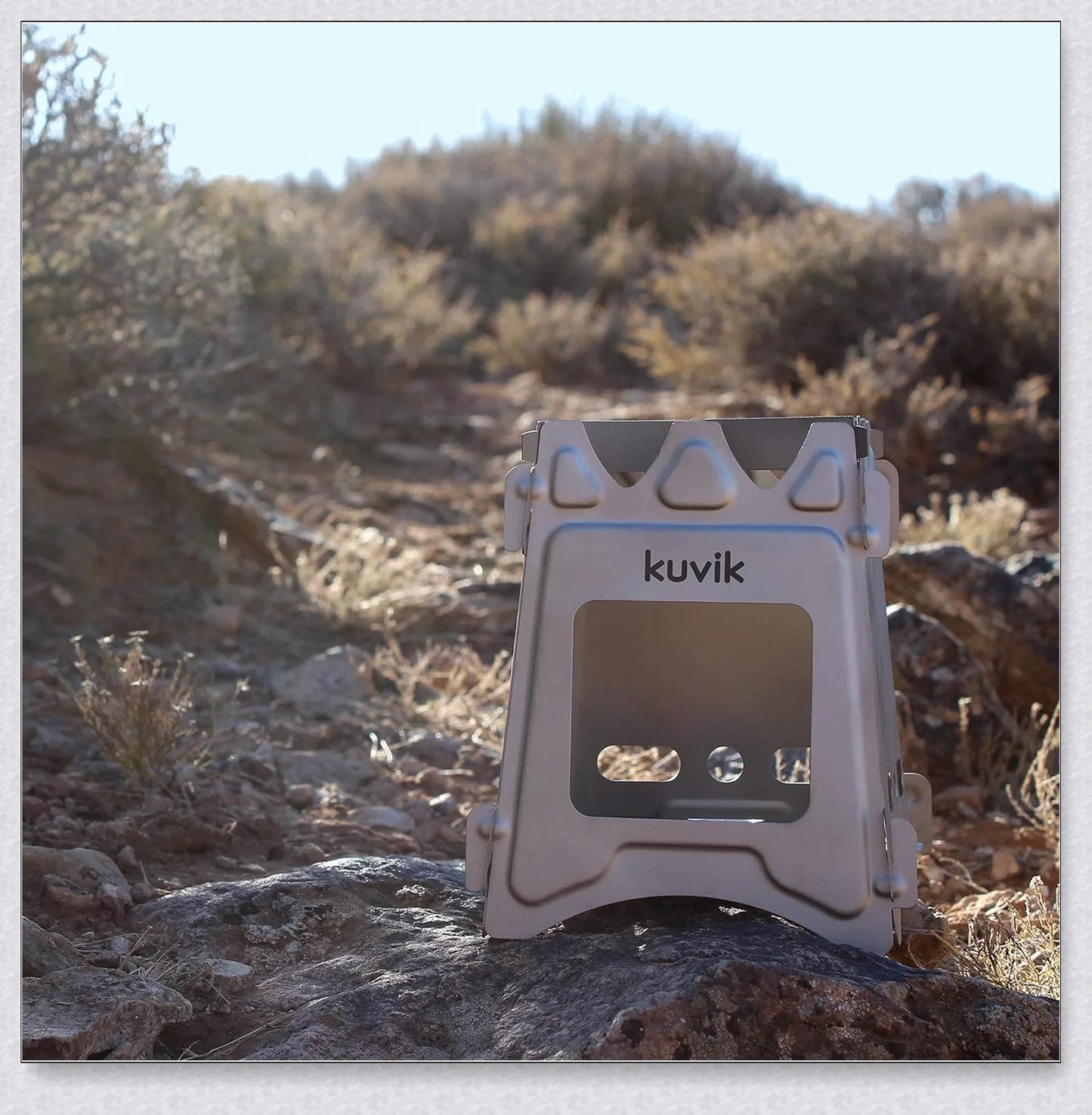 Portable titanium camping stove with folding design and open flame for cooking with natural fuels in the outdoors