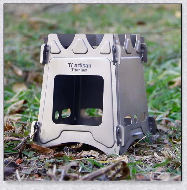 Portable titanium camping stove with folding design and open flame for cooking with natural fuels in the outdoors
