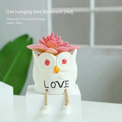 Ceramic hanging foot flowerpot for succulent plants with cartoon styling on desktop