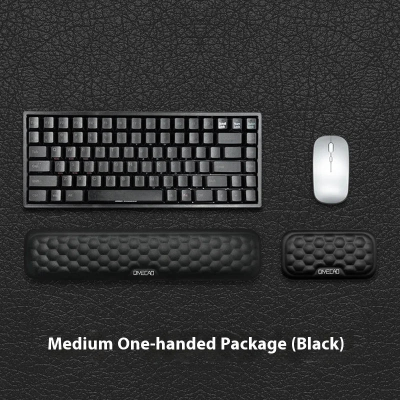 Black and grey memory foam mouse wrist rests with cloth and leather-style covers on a desk.