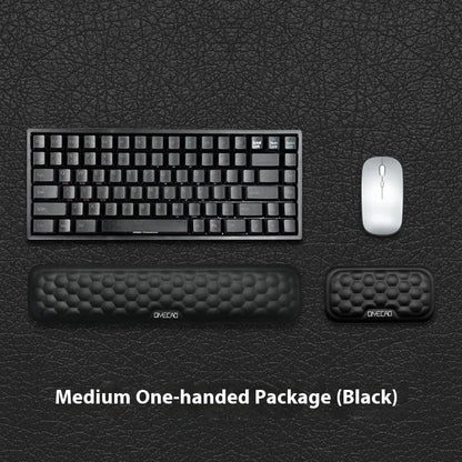 Black and grey memory foam mouse wrist rests with cloth and leather-style covers on a desk.