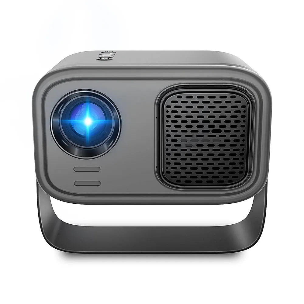 Black HD smart portable projector with remote control and cables on a table
