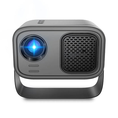 Black HD smart portable projector with remote control and cables on a table