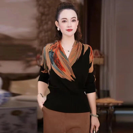 Black geometric floral pattern V-neck sweater with long sleeves and loose fit on hanger