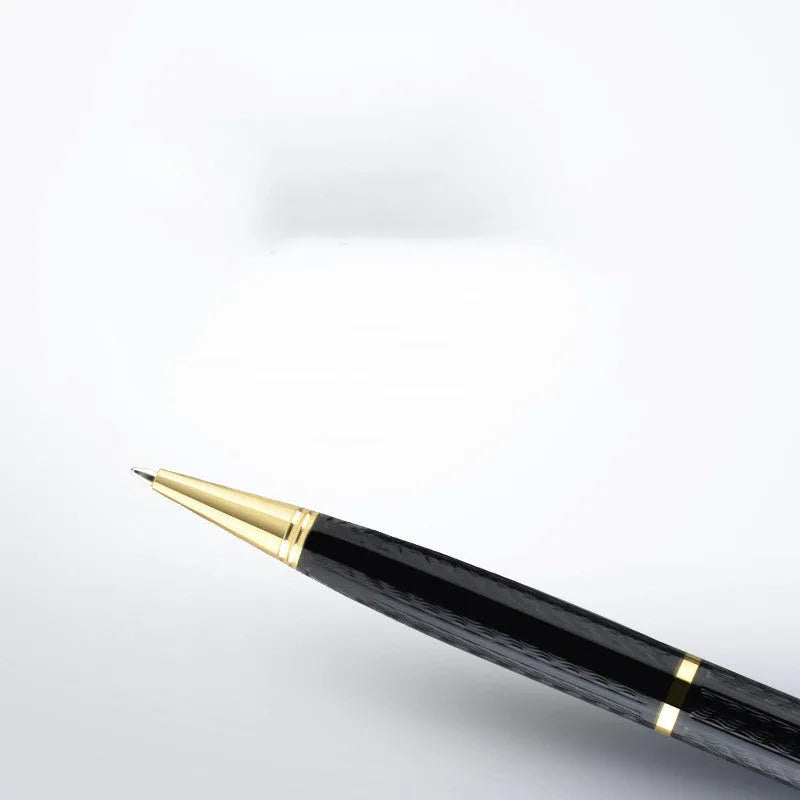 Black pen shaped digital voice recorder with zinc alloy body shown next to included USB cable.