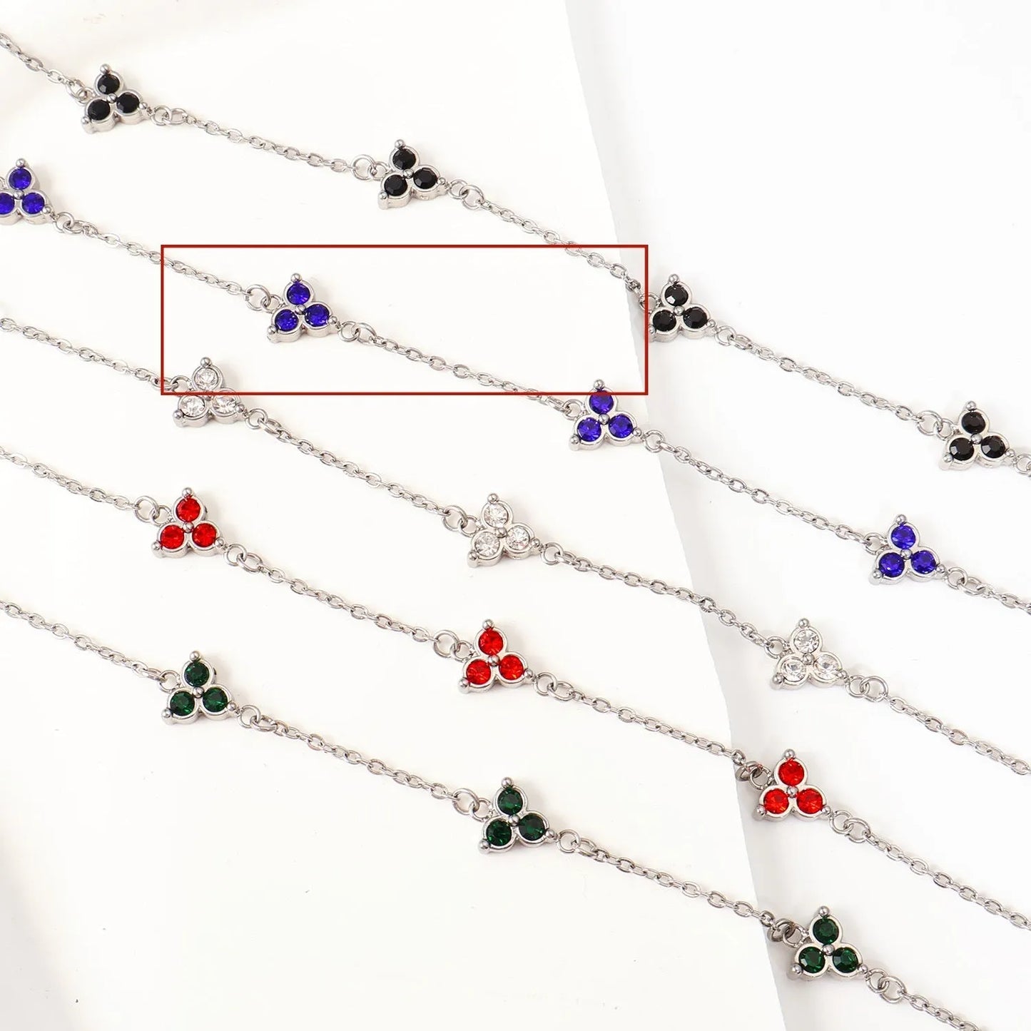Women's stainless steel bracelet with three triangle-shaped charms in different coloured stone settings