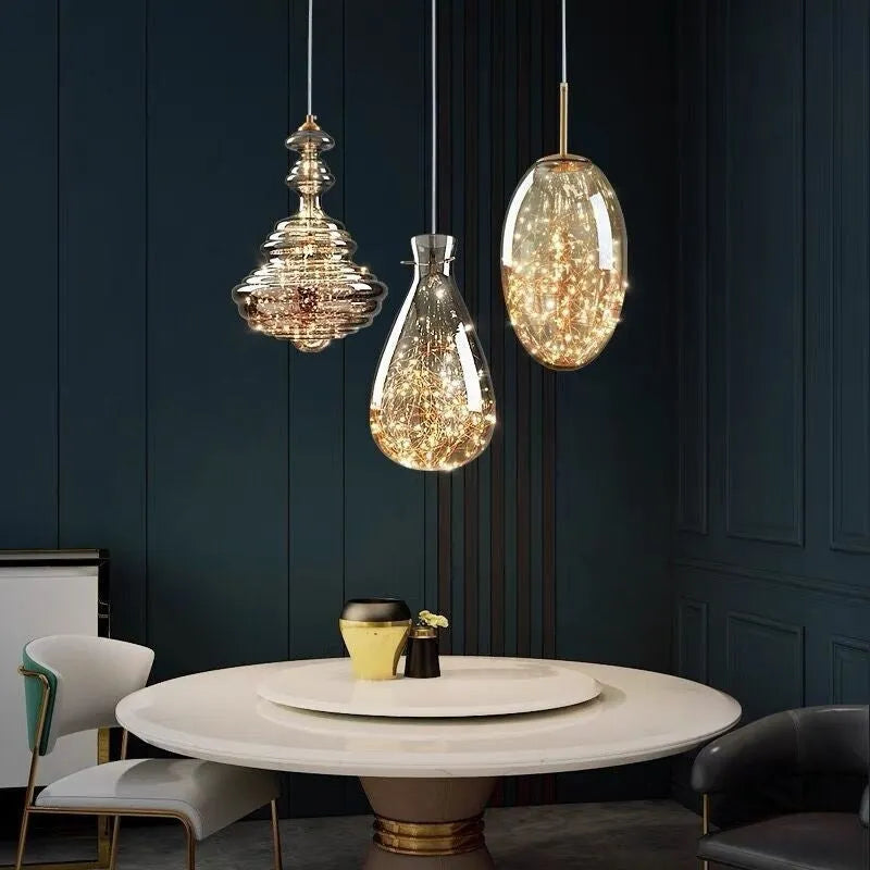Modern adjustable glass droplight chandelier with LED lighting on a long suspension cable.