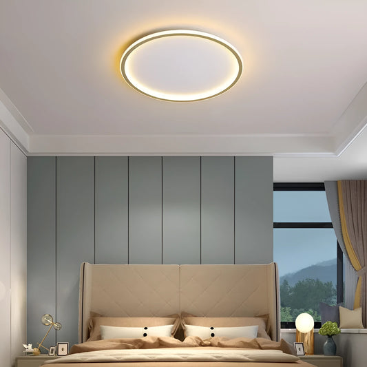 Minimalist circular ceiling lamp in gold finish mounted on a white ceiling