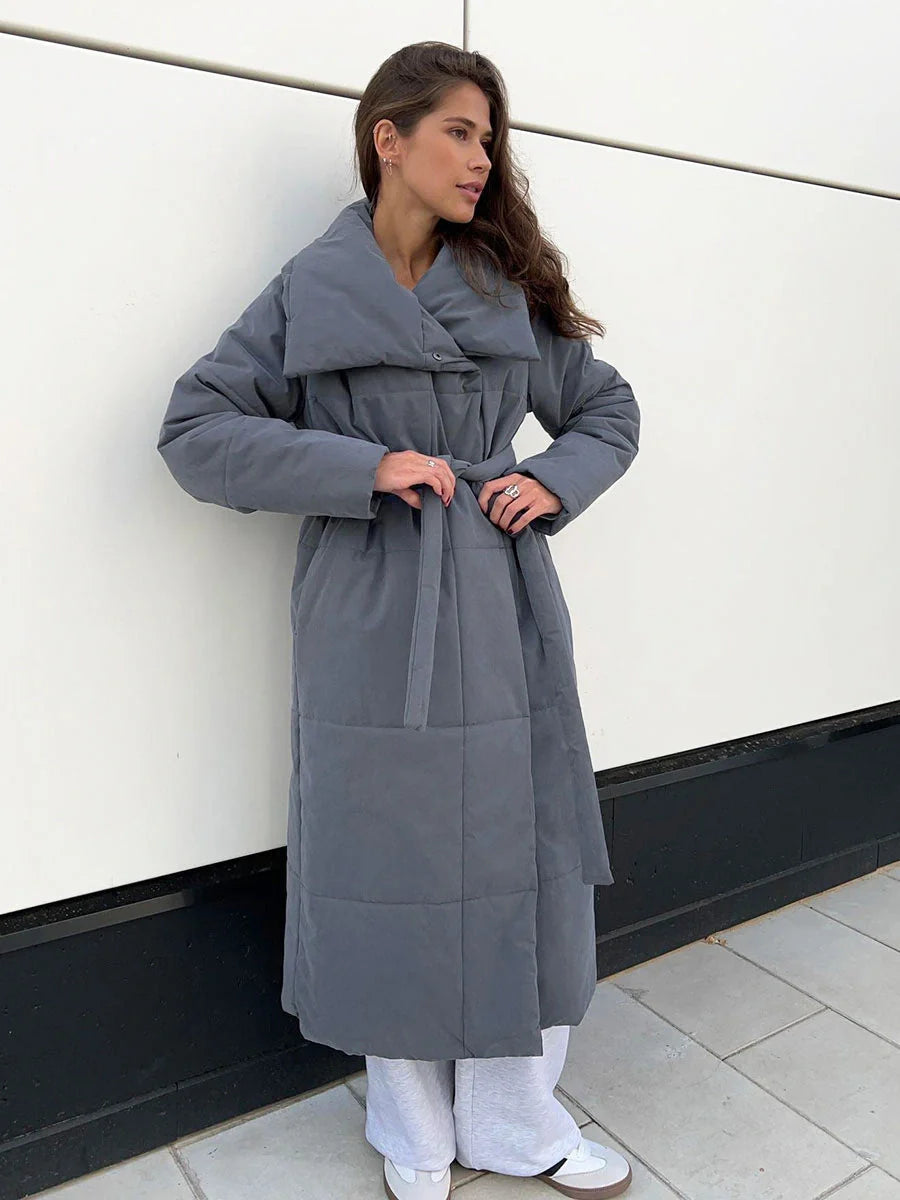 Cozy women's long winter coat with large lapel, lace-up design, and pockets for optimal warmth and style