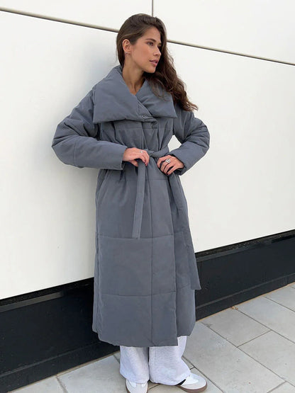 Cozy women's long winter coat with large lapel, lace-up design, and pockets for optimal warmth and style